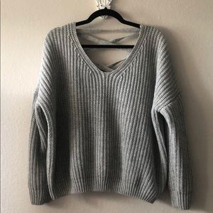 Gray cable knit sweater with criss cross back